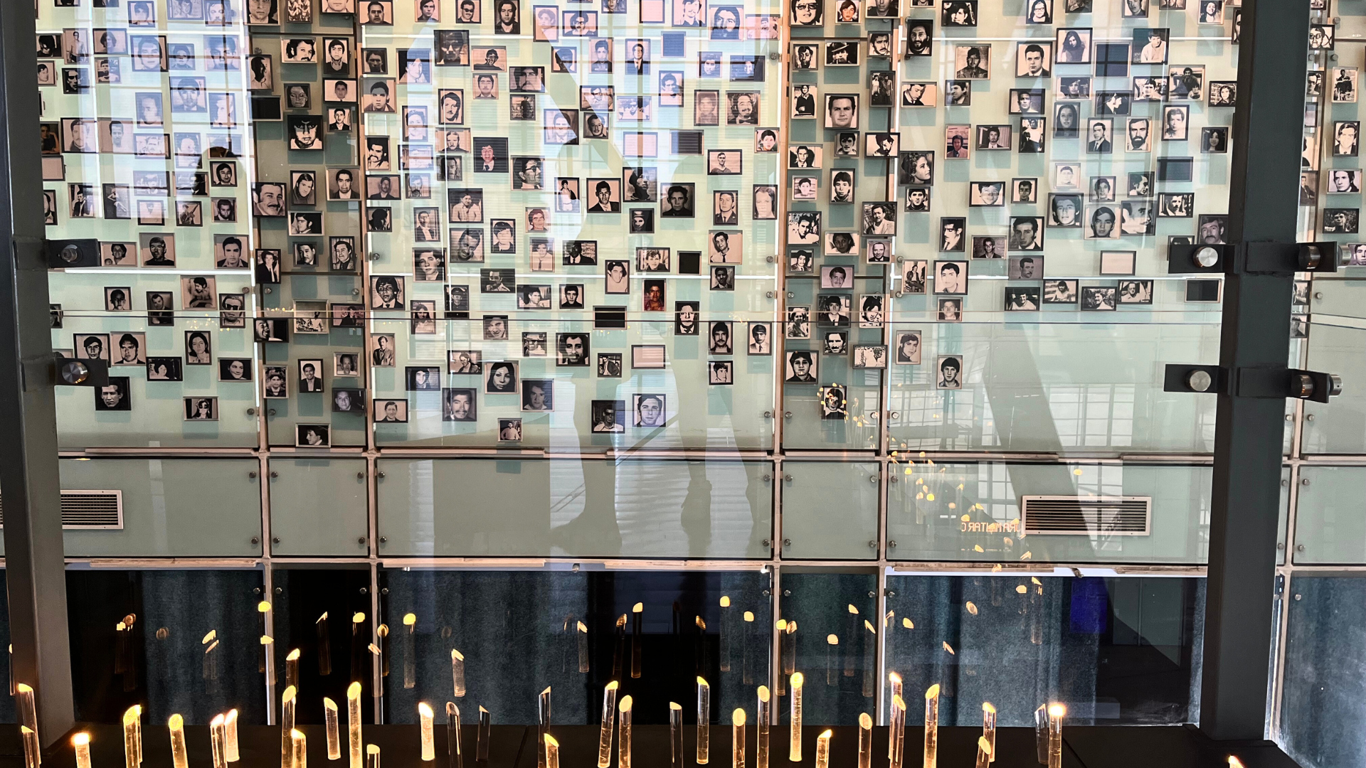 A photo from the Museum of Memory and Human Rights (MMDH) in Santiago, shows multiple photos of people hung on a wall.