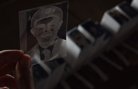 Artist Anıl Olcan, who is working on a micro-memorial for Turkey’s disappeared, is seen holding the negative of a photograph of Seyhan Doğan, one of the seven men who were forcibly disappeared in Dargeçit in 1995, up to the light.